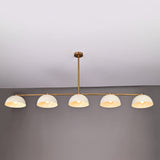 Full front view of 5-light linear brass chandelier with enamel dome shades and downrod ceiling mount in neutral interior
