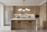 Closeup of linear ceiling light with glowing oval glass balls and warm brass frame details
