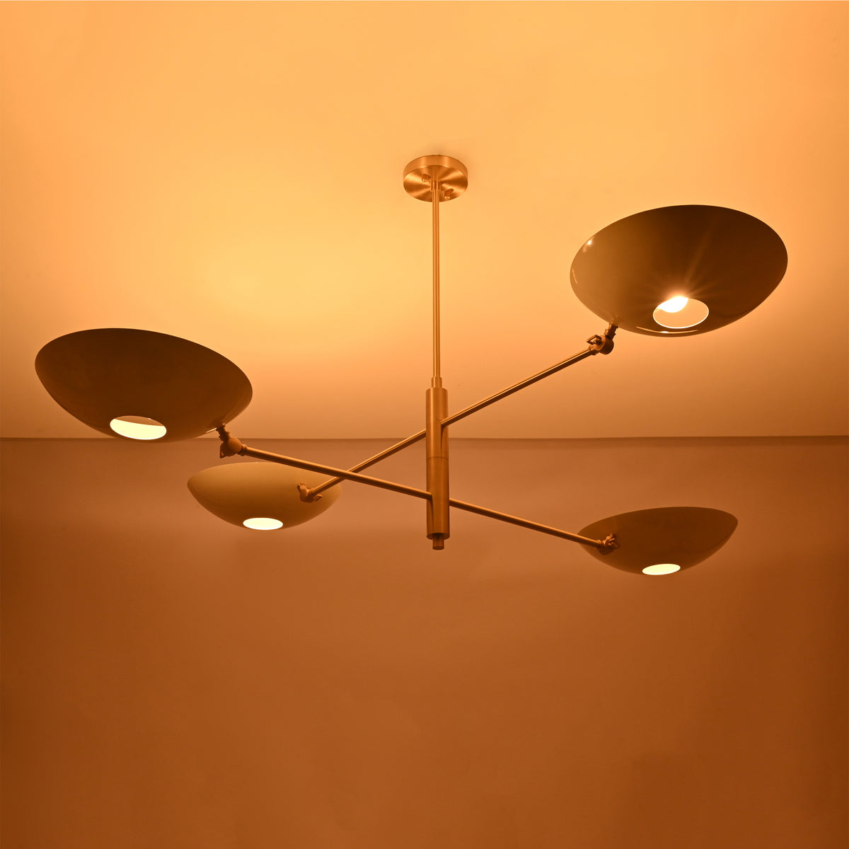 Linear saucer bowl chandelier with four curved shades and slim central stem for modern ceiling lighting