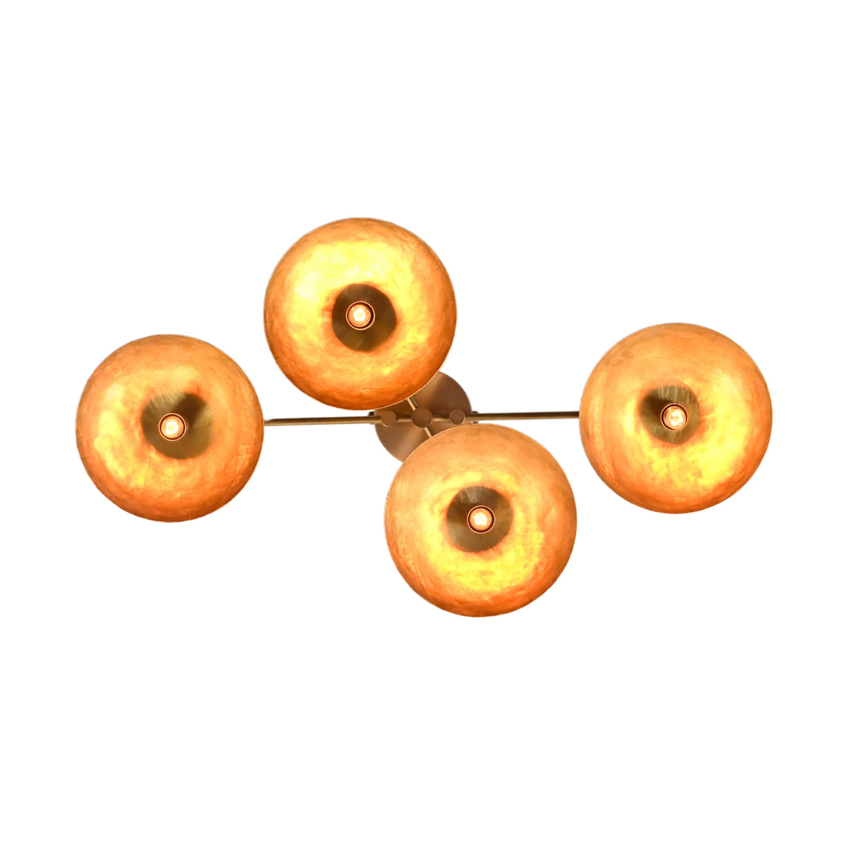 Illuminated top-down view of 4 glowing bowl shades on a brass flush mount chandelier.