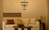 Brass chandelier with layered shades illuminating a cozy living room with neutral and earthy tones.