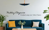Living room with velvet sofa and sculptural pendant light in blackened brass labeled “Midday Elegance.”