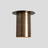 Side view of elongated brass cylinder flush mount ceiling light in brushed finish