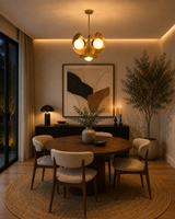 Lotus globe chandelier glowing warmly in a dim room with three opal globes and sculptural brass petal design
