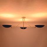 Low profile three-light brass flush mount ceiling fixture ideal for modern interiors