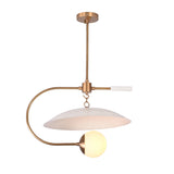 Modern globe pendant light with white saucer shade, frosted globe, and warm brass ceiling rod