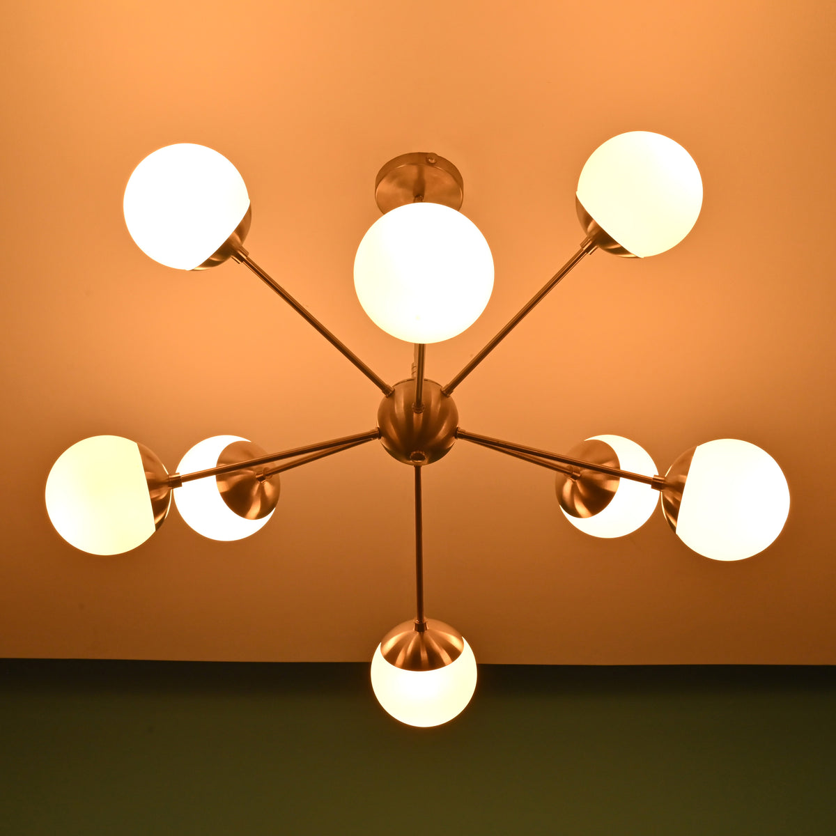Luxury 8 light brass chandelier with opal globes providing warm ambient illumination for refined interiors
