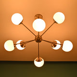 Luxury 8 light brass chandelier with opal globes providing warm ambient illumination for refined interiors