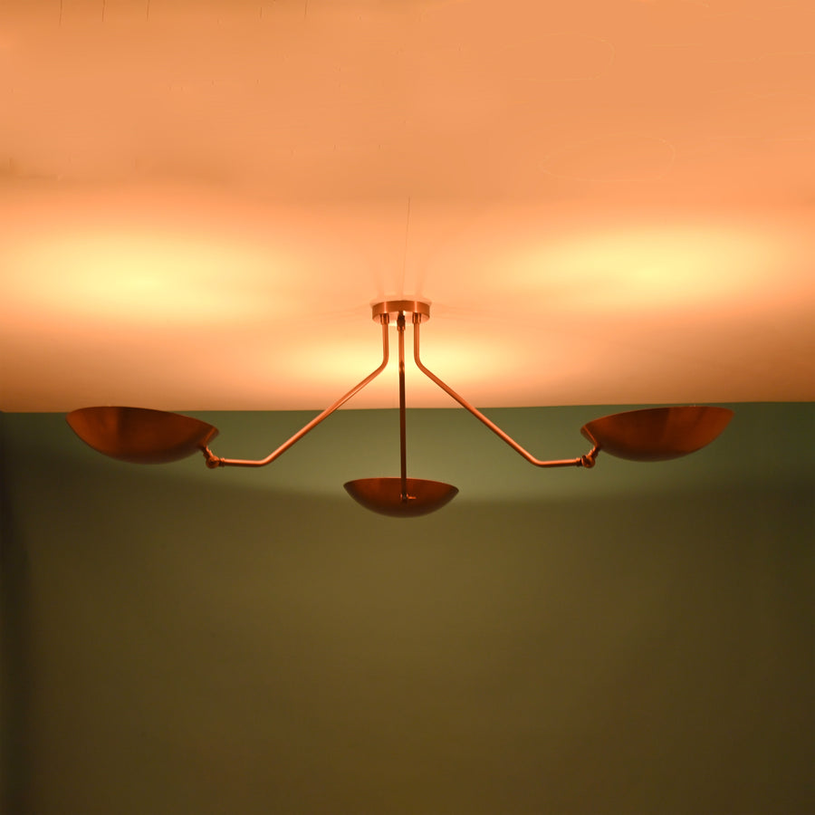 Modern 3 light brass flush mount ceiling light with bowl shaped shades and clean minimalist industrial arms