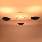 Luxury handcrafted brass flush mount ceiling light casting a warm evening glow across the ceiling