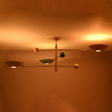 Luxury handcrafted brass flush mount ceiling light showcasing artistic multicolor bowls under warm lighting