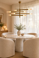 Mid century inspired tubular chandelier with layered brass arms and eight illuminated ends