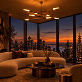 Modern linear ceiling light in raw brass with four horizontal arms and eight glowing light ends