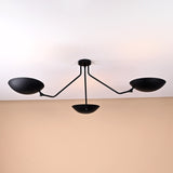 Modern minimalist ceiling light with three bowl-shaped brass shades in matte black finish for elegant interiors