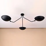 Contemporary matte black brass ceiling fixture featuring three balanced arms and smooth geometric bowl shades