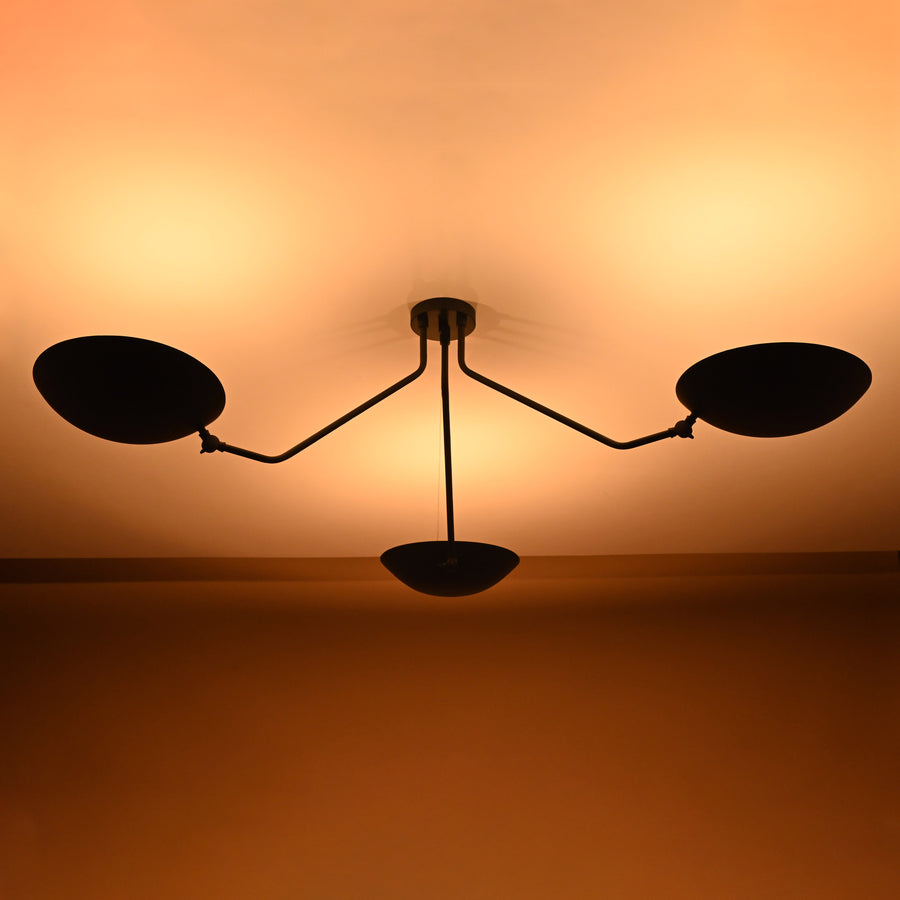 Modern minimalist ceiling light with three bowl-shaped brass shades in matte black finish for elegant interiors