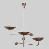 Modern handcrafted brass chandelier featuring three bowl-shaped shades and geometric balance-arm design