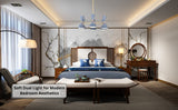 Mid-century modern dual-cone brass chandelier in a contemporary bedroom with soft lighting and blue accents.