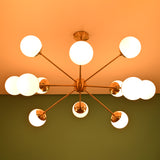 Mid century brass chandelier casting soft ceiling glow with opal glass globe shades