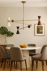 Mid-century brass 6-light diabolo chandelier suspended above dining table with minimalist interior styling