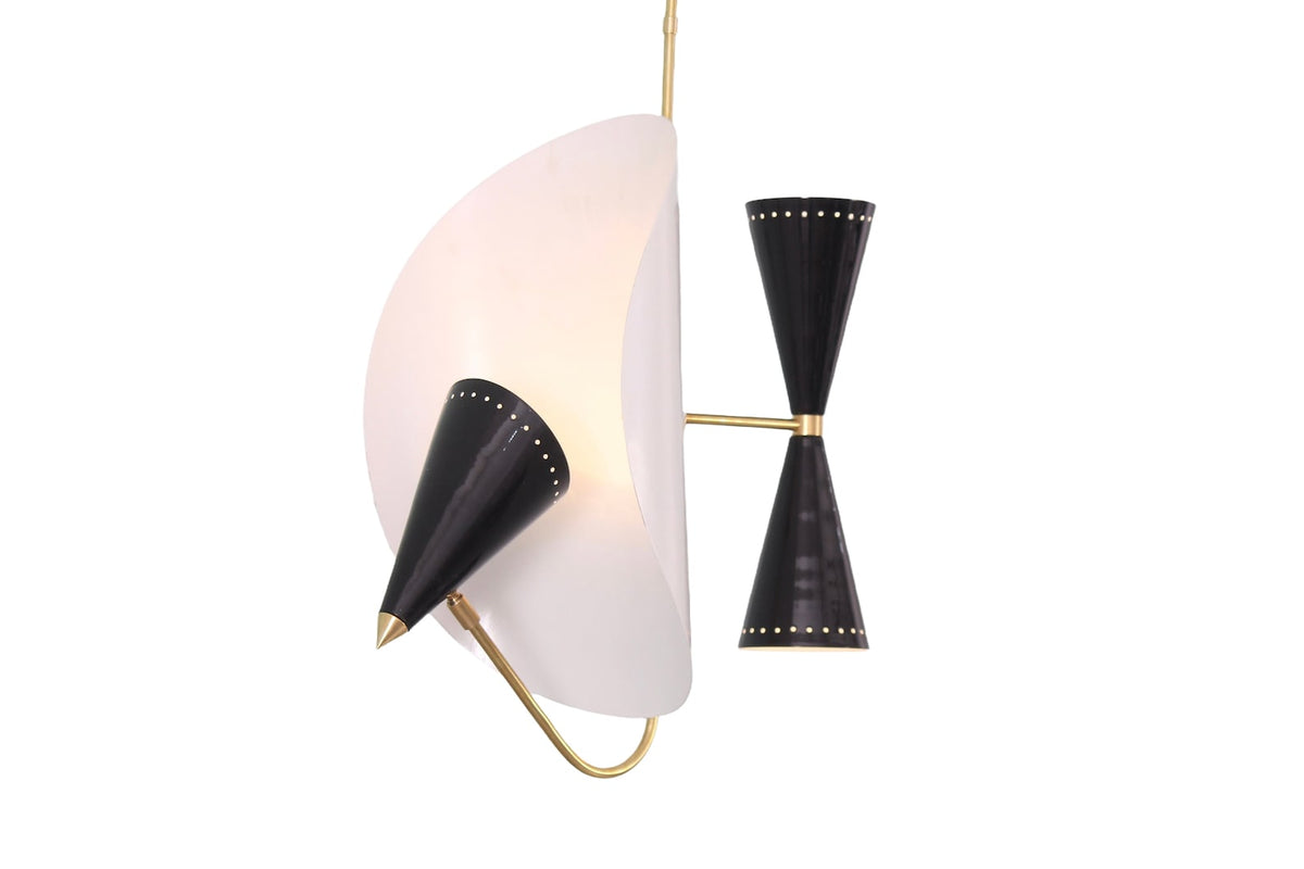 Side angle of mid century modern brass pendant light featuring sculptural white disc and perforated black cone shades