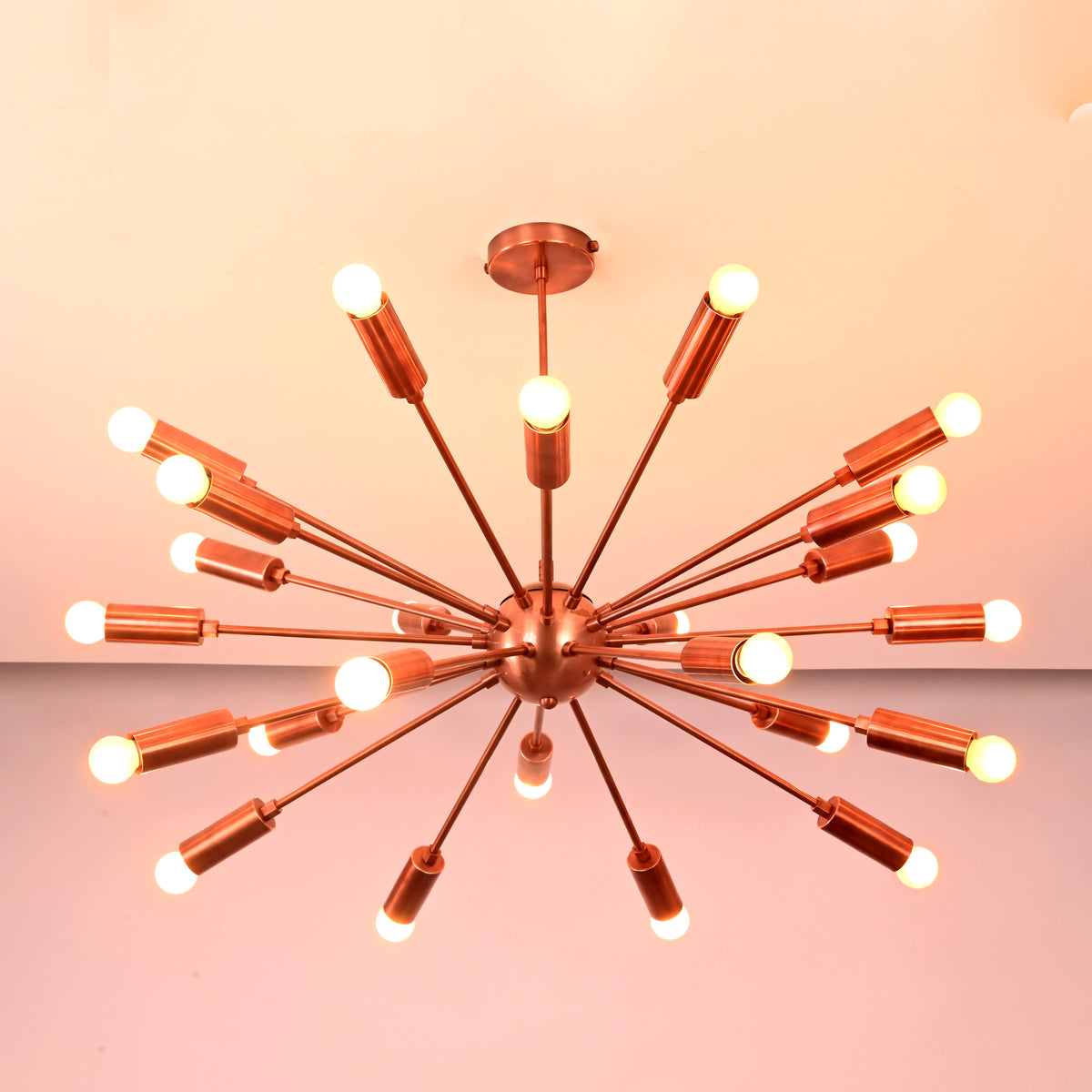 Ceiling view of mid century modern brass sputnik chandelier with evenly spaced illuminated arms.