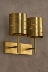 Mid-century modern dual wall sconce in brushed brass with slotted cylindrical shades and rectangular backplate, industrial designer lighting fixture
