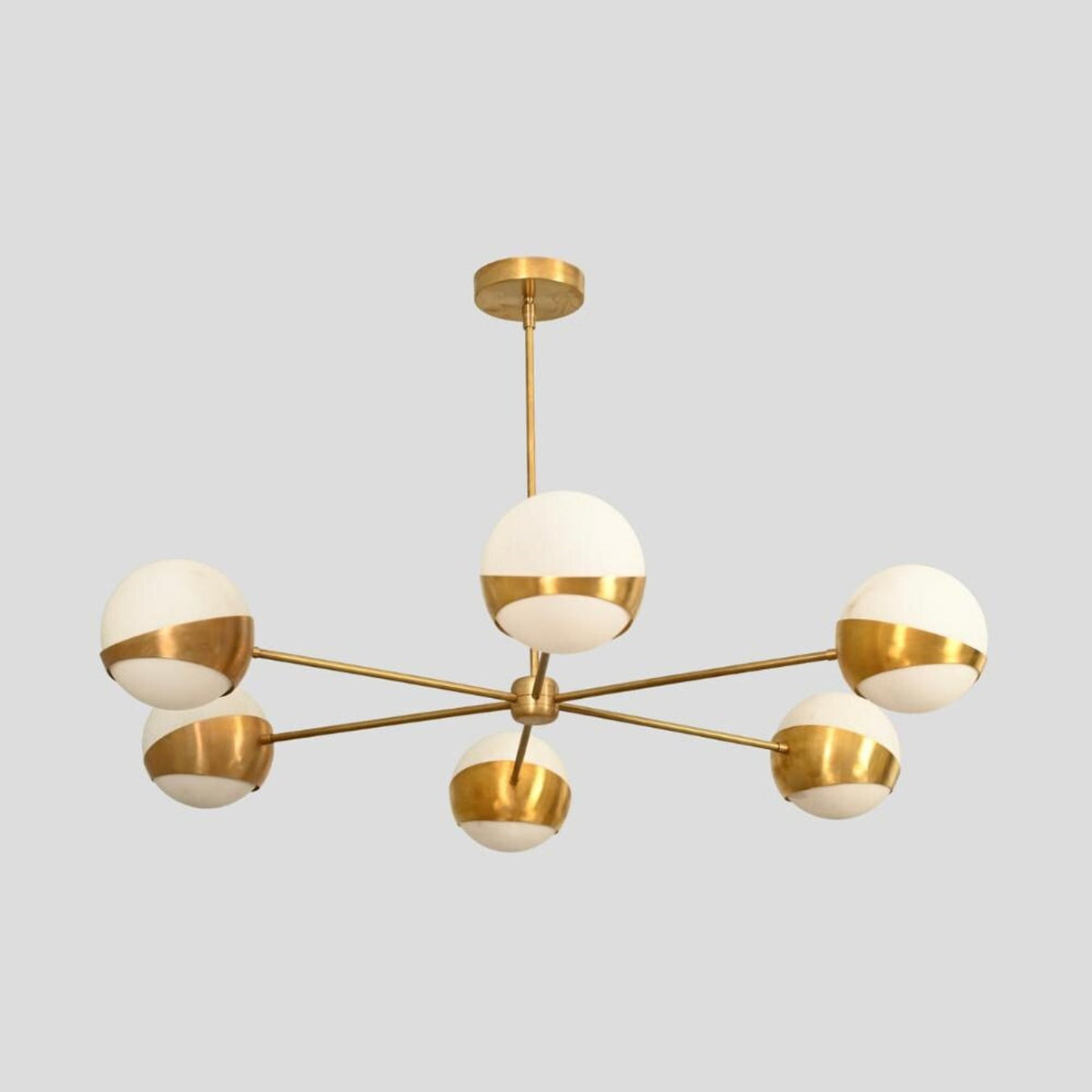 Mid-century modern brass chandelier with six white glass globes, handcrafted minimalist ceiling light.