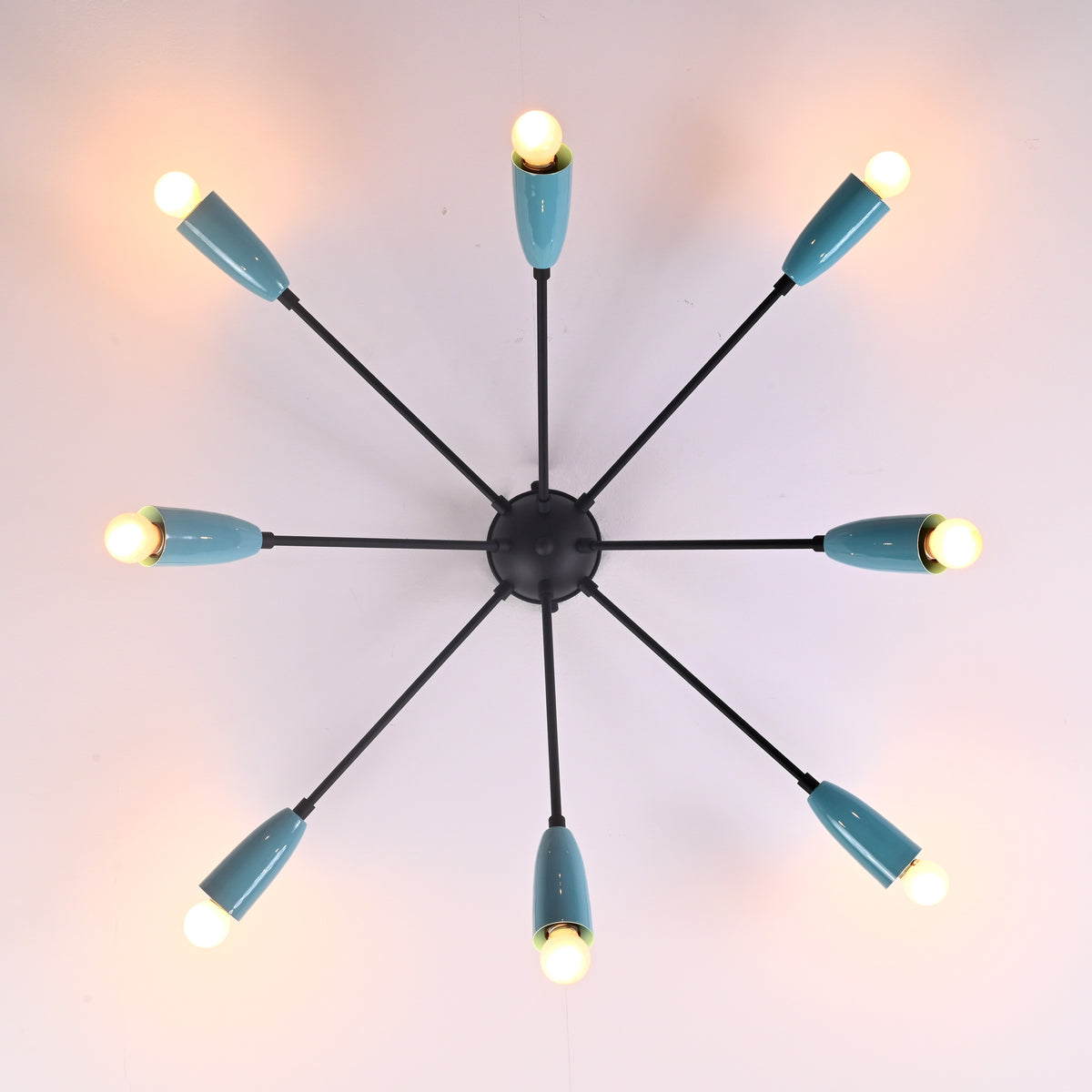 Top view of mid-century orbit 8-light brass flush mount chandelier with angled arms and cone shades by Brass Leaf Studio