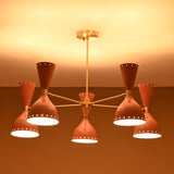 Mid-century modern peach and brass chandelier glowing warmly in ambient lighting