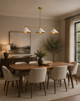 Milan 3 Light Linear Cone Pendant Chandelier with white shades installed above modern dining room table