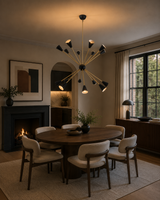 Milan Noir 16 light starburst cone chandelier with black shades and brass arms styled above a modern dining table