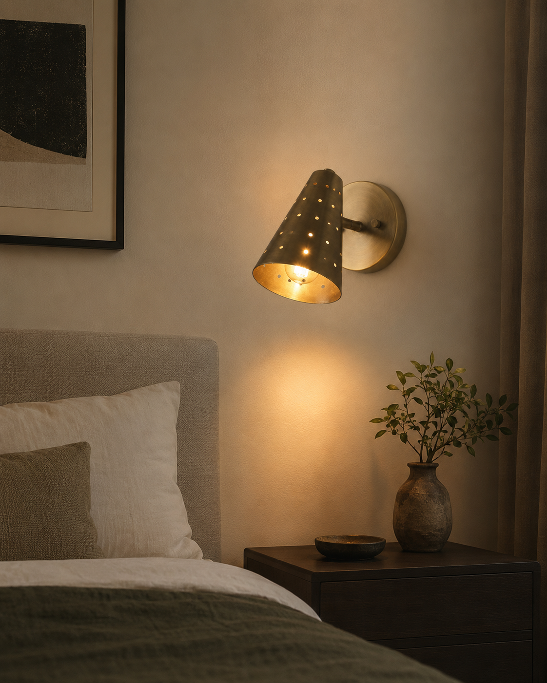 Milan perforated cone wall sconce installed beside a bed with warm ambient lighting – Model 32757