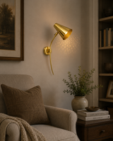 Milan perforated cone wall sconce illuminated in cozy living room reading corner – Model 32804