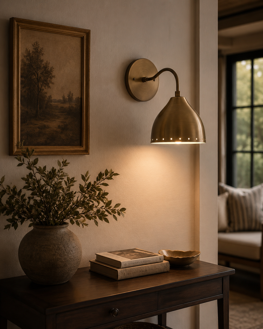 Milan perforated dome wall sconce installed above console table in warm modern interior – Model 32749