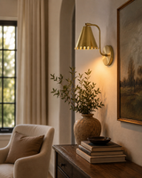 Milan scalloped cone brass wall sconce installed in a warm modern living room interior – Model 32756