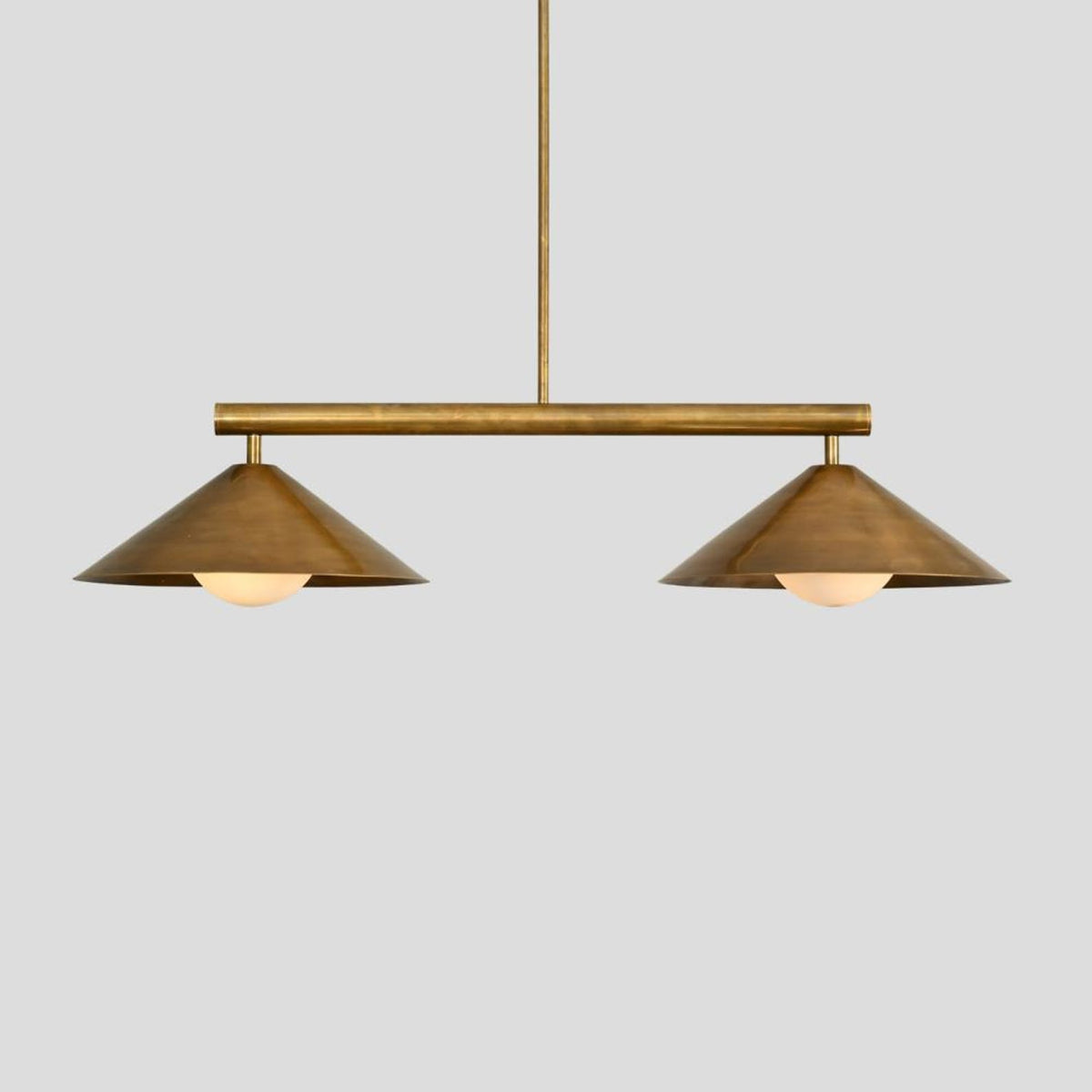 Minimalist 2-light brass chandelier with geometric cone shades, ideal for contemporary dining areas, offices, and cafes.