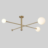 Minimalist brass ceiling fixture featuring three opal glass globes and brushed brass finish.