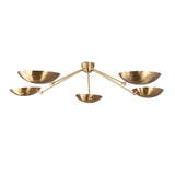 Minimalist brass ceiling chandelier with bowl shades creating soft indirect uplighting.