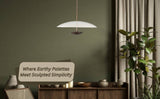 Minimalist brass pendant lamp styled in an earthy-toned interior, blending sculpted simplicity with warm ambient lighting for elegant living spaces.