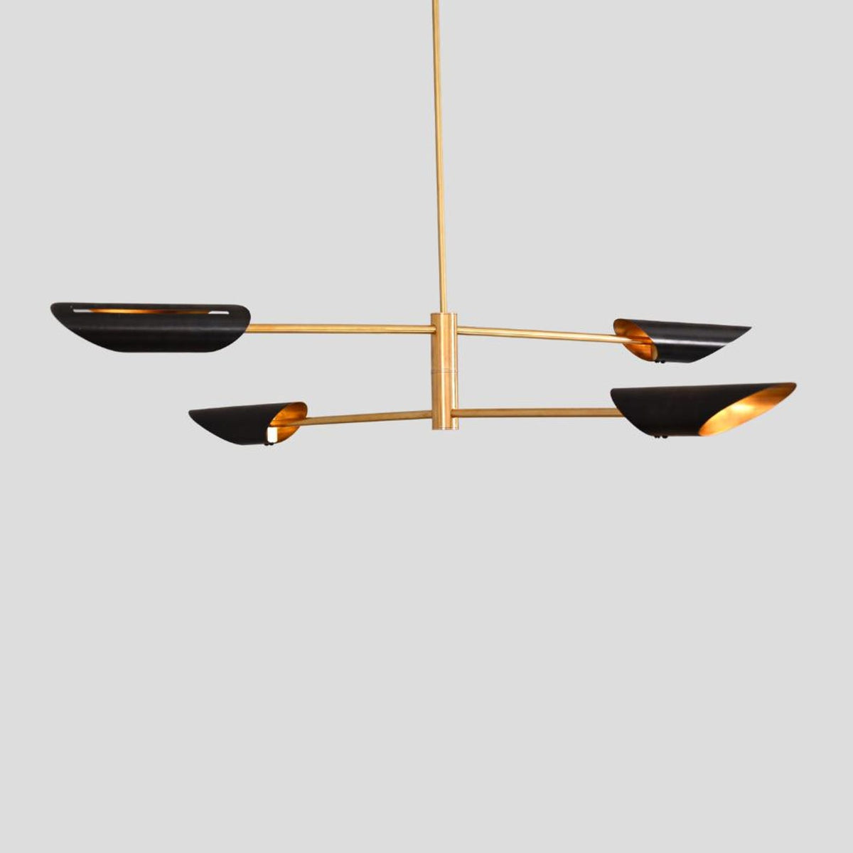 Minimalist industrial chandelier in brushed brass with black bowl shades, handcrafted lighting by Brass Leaf Studio.