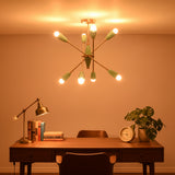 Mint green brass chandelier shown illuminated with warm upward, downward, and outward light spread