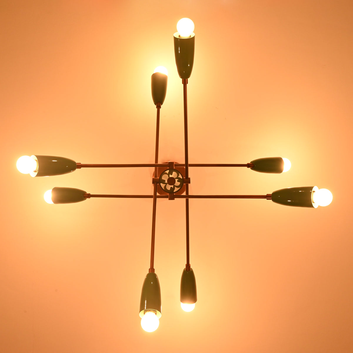 Underside detail of mint green brass sputnik chandelier showcasing handcrafted structure and warm light.