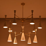 Modern 12-light cone chandelier shown on white background with brushed brass structure and white enamel painted shades