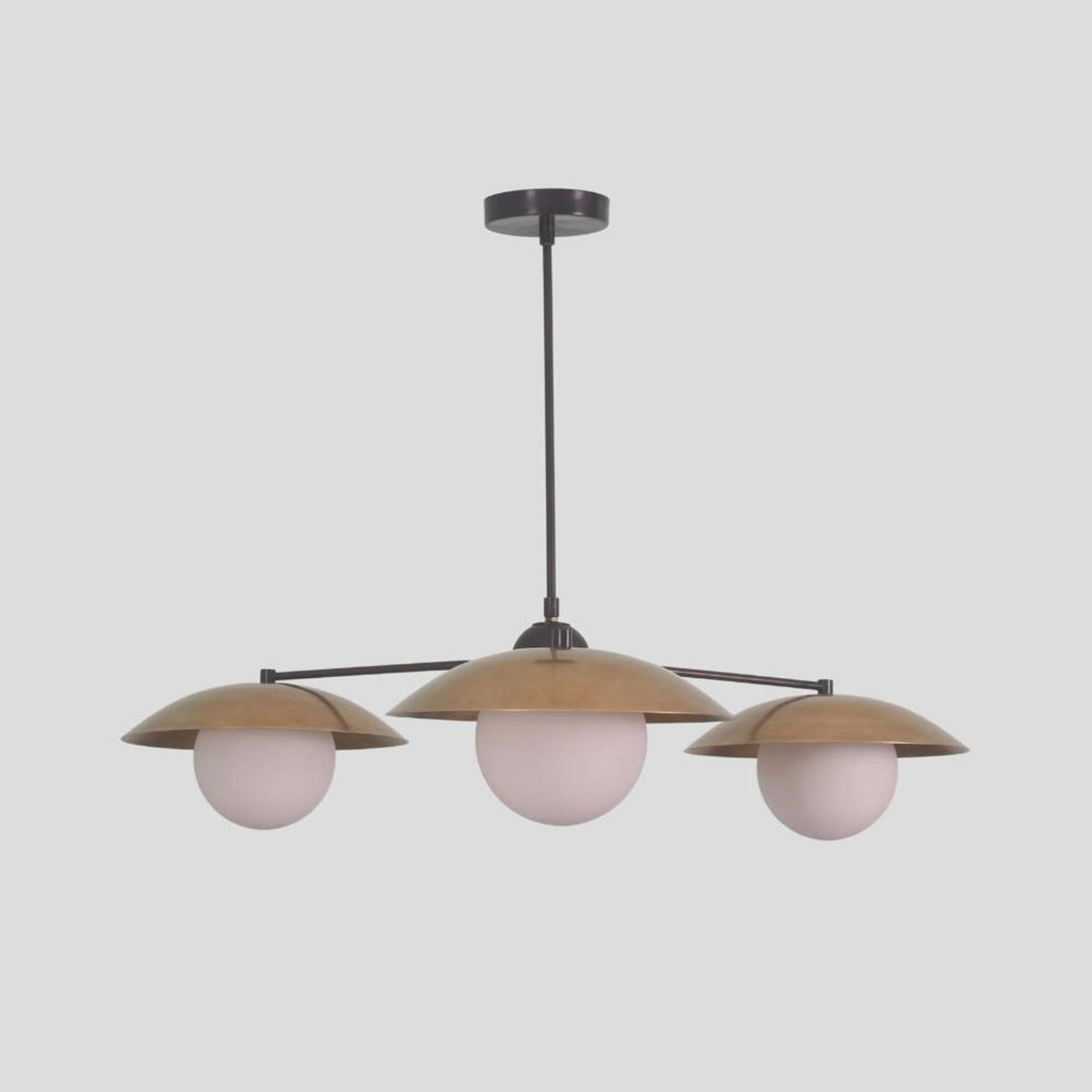 Handmade brass chandelier featuring three globe diffusers with dome brass shades, perfect for contemporary dining rooms and interiors.