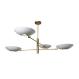 Contemporary brass chandelier featuring four elegant white bowl-shaped shades and minimalist linear design