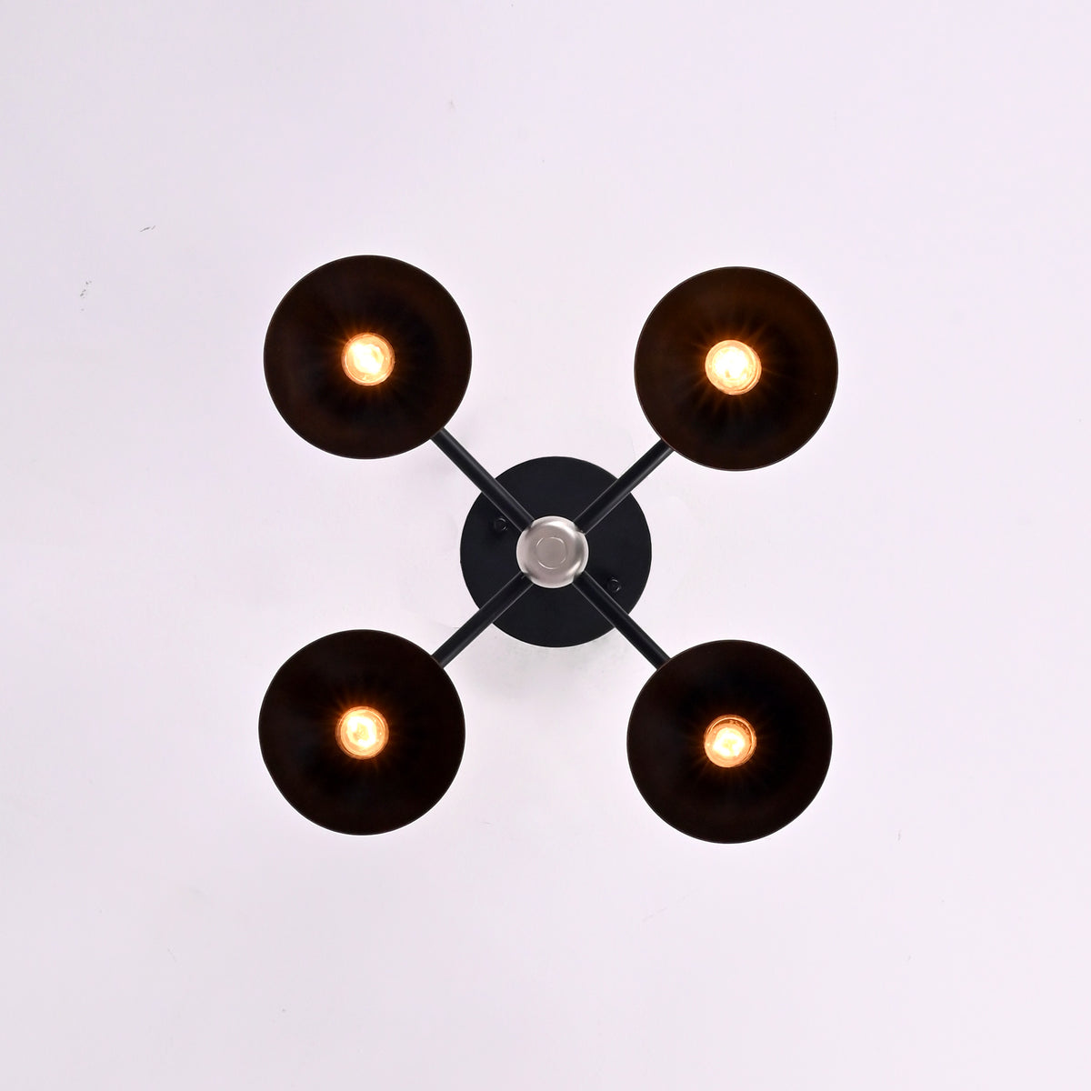 Top view of 4 light black and brass flush mount chandelier with round dome shades