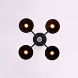 Top view of 4 light black and brass flush mount chandelier with round dome shades