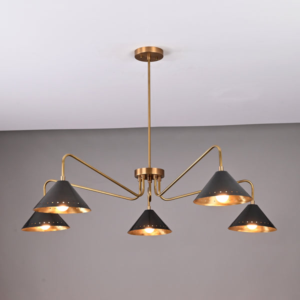 Front view of handcrafted 5-light brass chandelier featuring matte-black perforated cone shades and brushed brass arms.