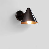 Modern antique brass cone wall sconce illuminated with soft ambient light, ideal for bedrooms, hallways, and living areas.